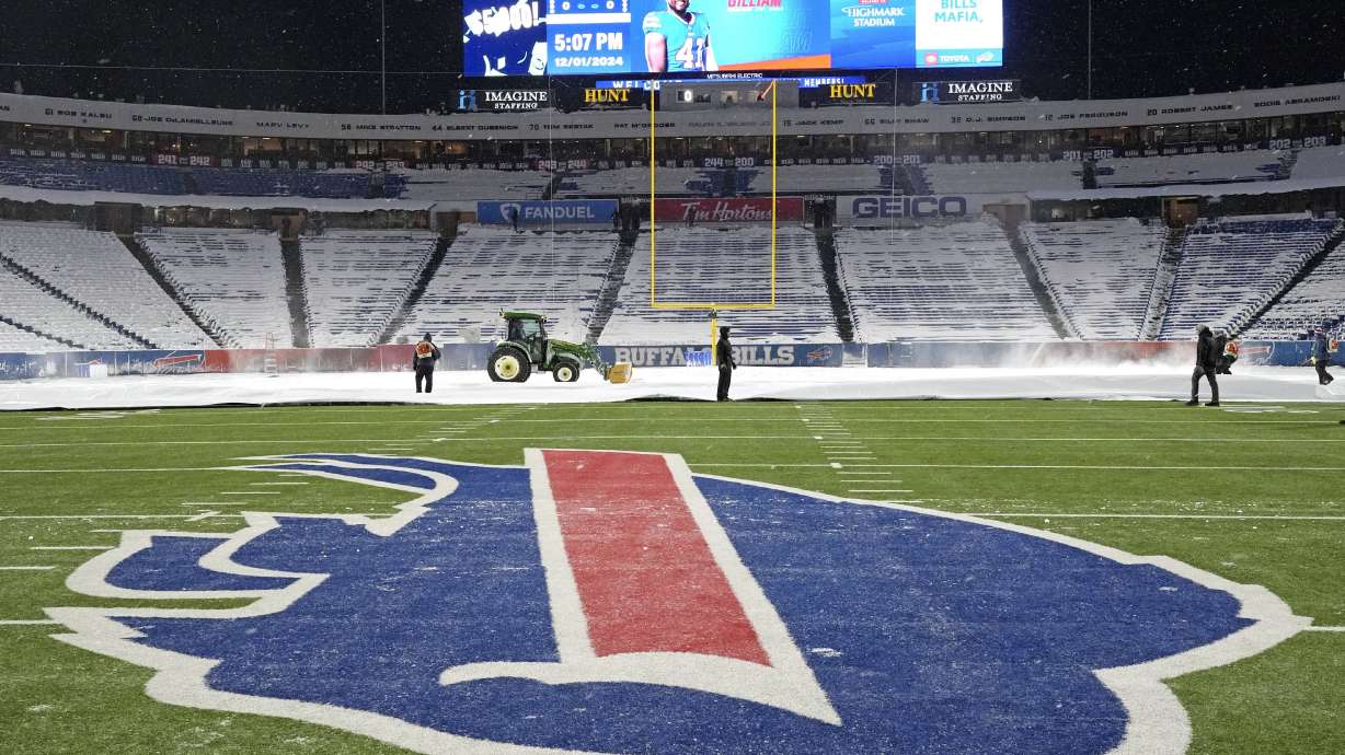 Workers clear snow in Highmark Stadium in preparation for a Sunday Night Football game between the Buffalo Bills and the San Francisco 49ers in Orchard Park, N.Y., Sunday, Dec. 1, 2024.