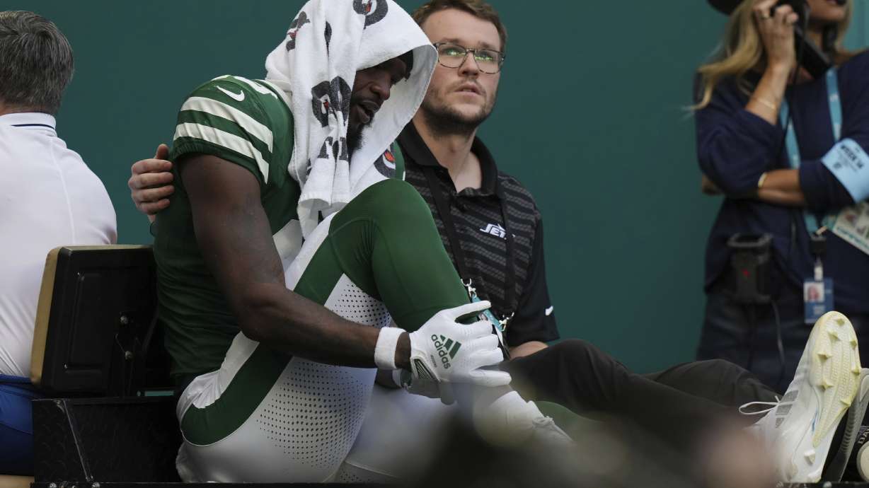 New York Jets wide receiver Irvin Charles is assisted off the field during the second half of an NFL football game against the Miami Dolphins, Sunday, Dec. 8, 2024, in Miami Gardens, Fla.