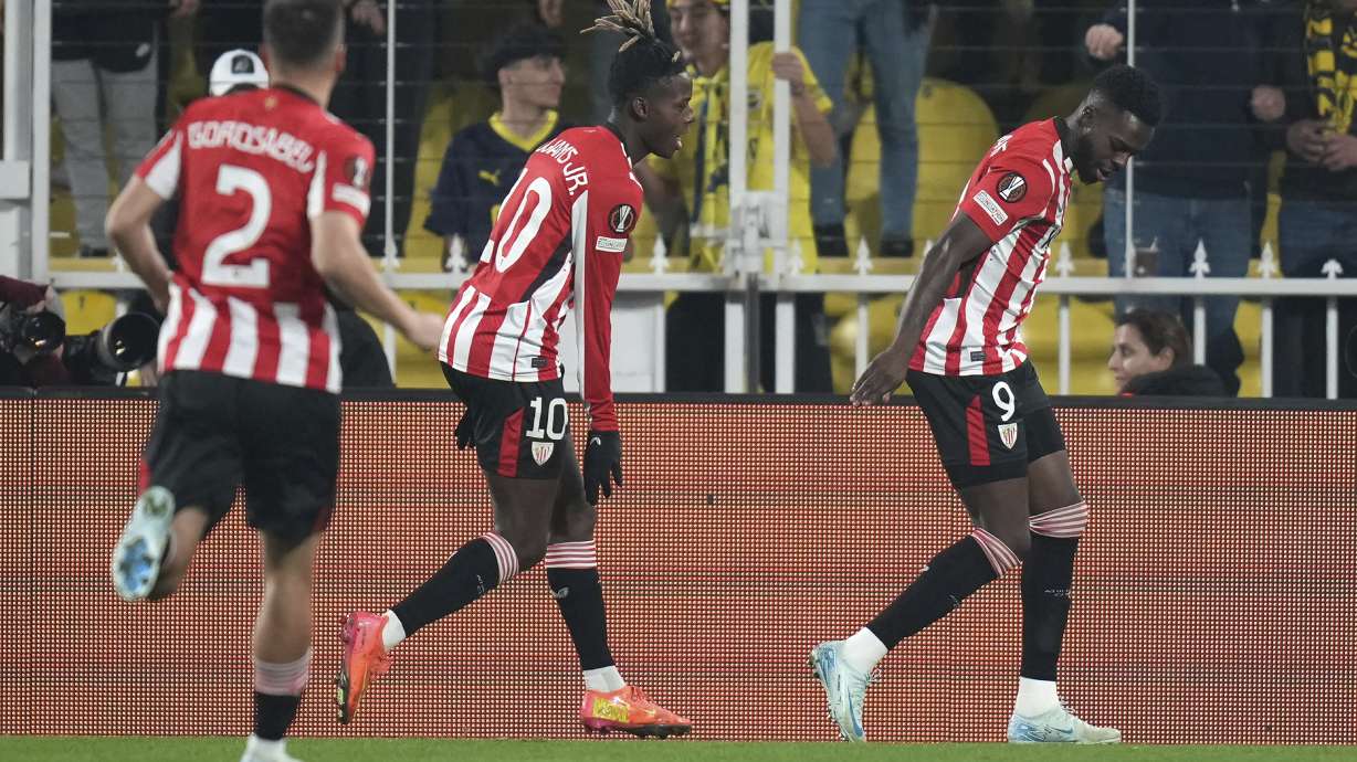 Athletic Bilbao's Inaki Williams, right, celebrates after scoring the opening goal during the Europa League opening phase soccer match between Fenerbahce and Athletic Bilbao at Sukru Saracoglu stadium, in Istanbul, Turkey, Wednesday, Dec. 11, 2024.