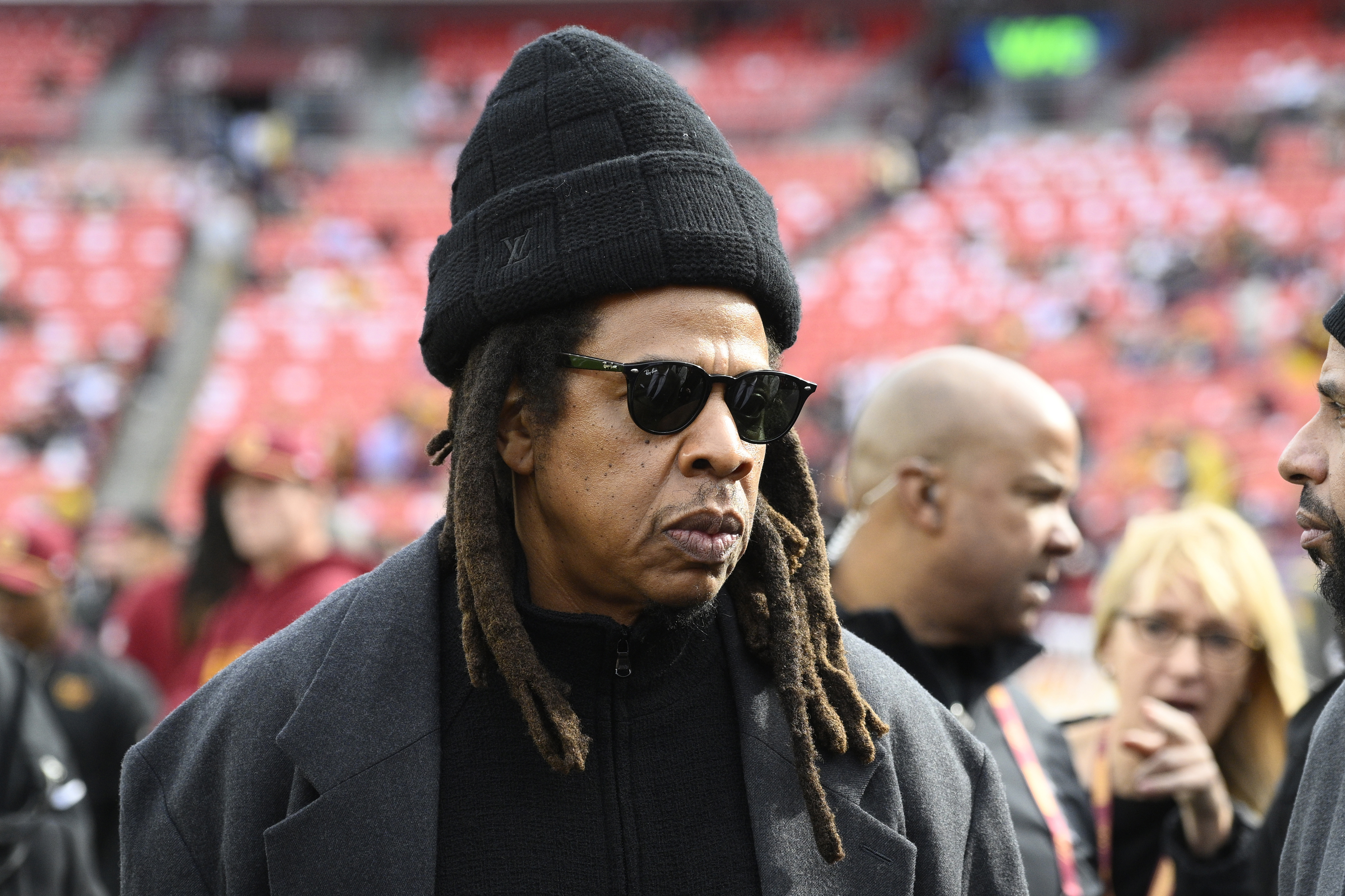 FILE - Musician Jay-Z stands on the field before an NFL football game between the Washington Commanders and Dallas Cowboys, on Nov. 24, 2024, in Landover, Md.