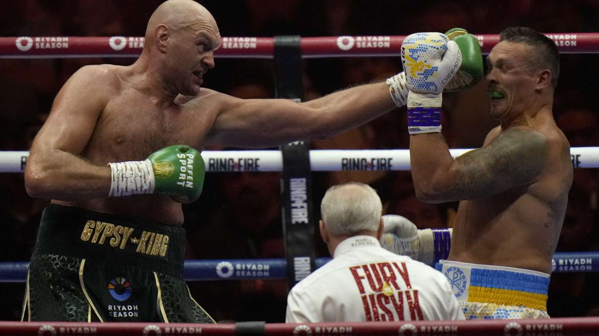 FILE - Britain's Tyson Fury, left, punches Ukraine's Oleksandr Usyk during their undisputed heavyweight world championship boxing fight at the Kingdom Arena in Riyadh, Saudi Arabia, May 19, 2024.