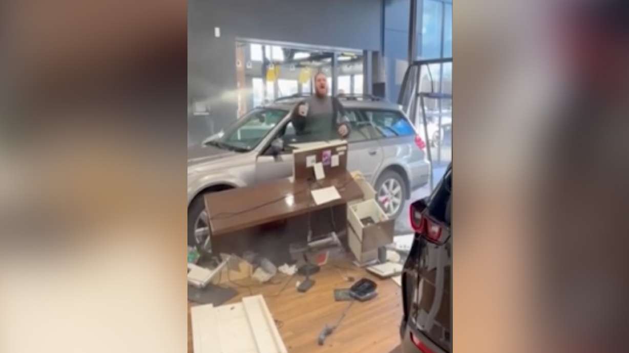 Cellphone video shows an angry customer driving through the doors at the Tim Dahle Mazda dealership in Sandy on Dec. 9, 2024, after the customer was allegedly denied a refund.