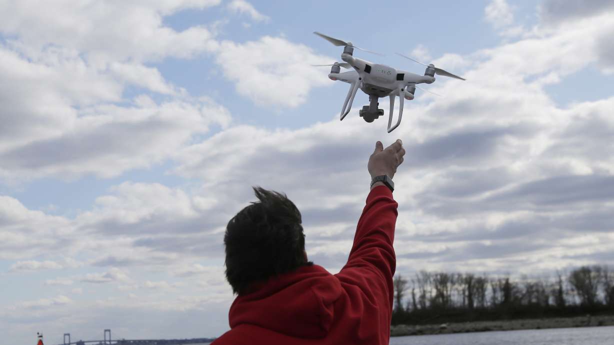 A drone operator helps to retrieve a drone after photographing over Hart Island in N.Y. Multiple large drones have been spotted in the skies over neighboring New Jersey in recent days.