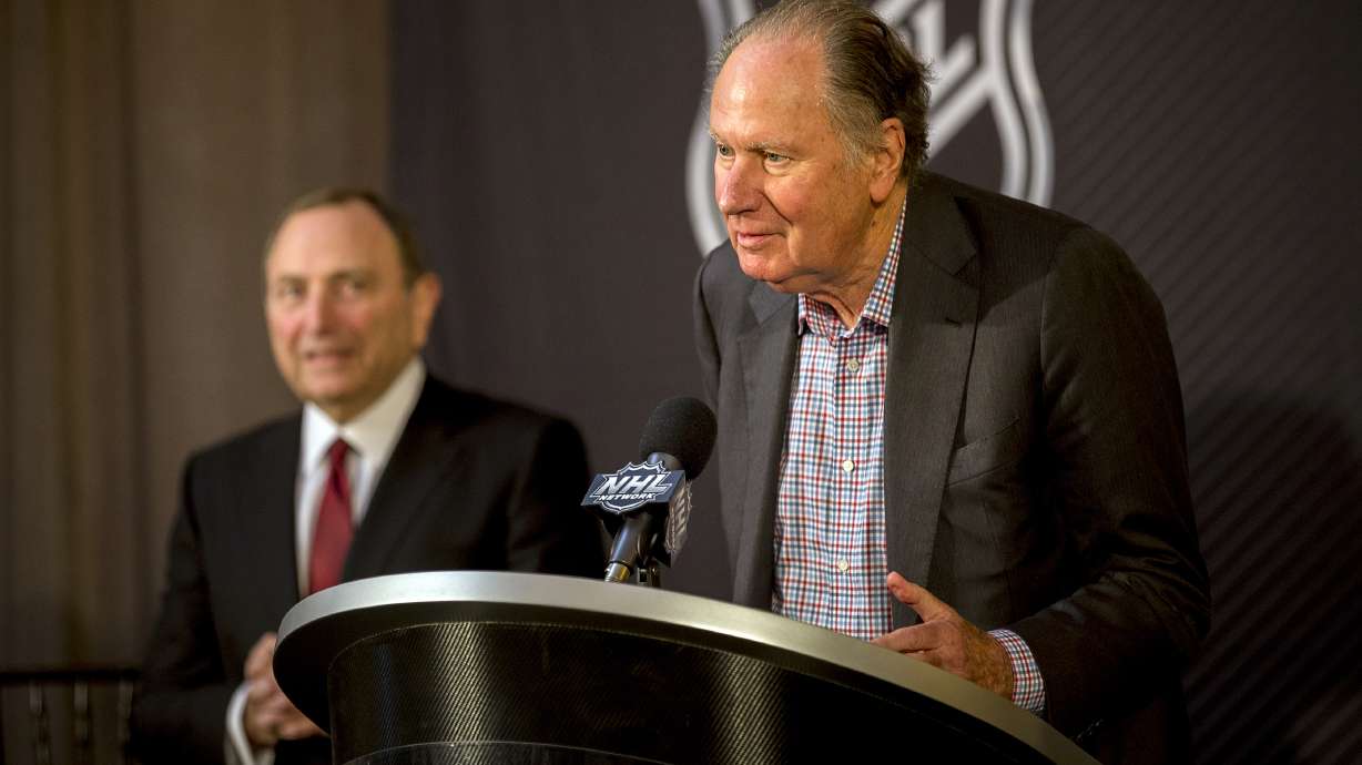 FILE - Seattle Kraken founding owner David Bonderman, right, steps up to the podium after the National Hockey League Commissioner Gary Bettman, left, named Seattle as the league's 32nd franchise, Dec. 4, 2018, in Sea Island, Ga.