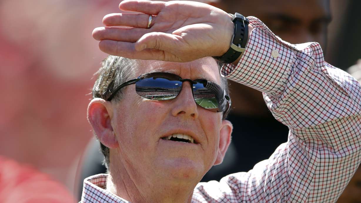 FILE - Sanford Stadium is reflected in Georgia athletic director Greg McGarity's sunglasses as he watches a pregame performance by rapper Ludacris before Georgia's spring intrasquad NCAA college football game Saturday, April 16, 2016, in Athens, Ga.