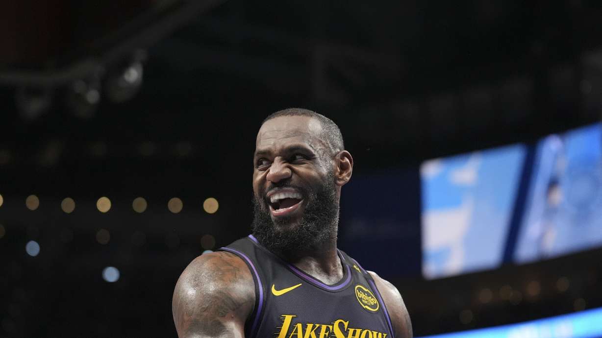 Los Angeles Lakers forward LeBron James (23) laughs on the court in the second half of an NBA basketball game against the Atlanta Hawks, Friday, Dec. 6, 2024, in Atlanta.