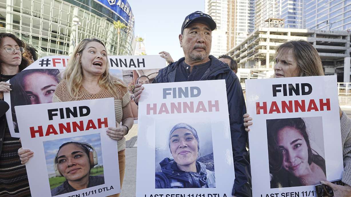Ryan Kobayashi, center, holds a picture of his missing daughter Hannah Kobayashi outside Crypto.com Arena, Nov. 21 in Los Angeles.