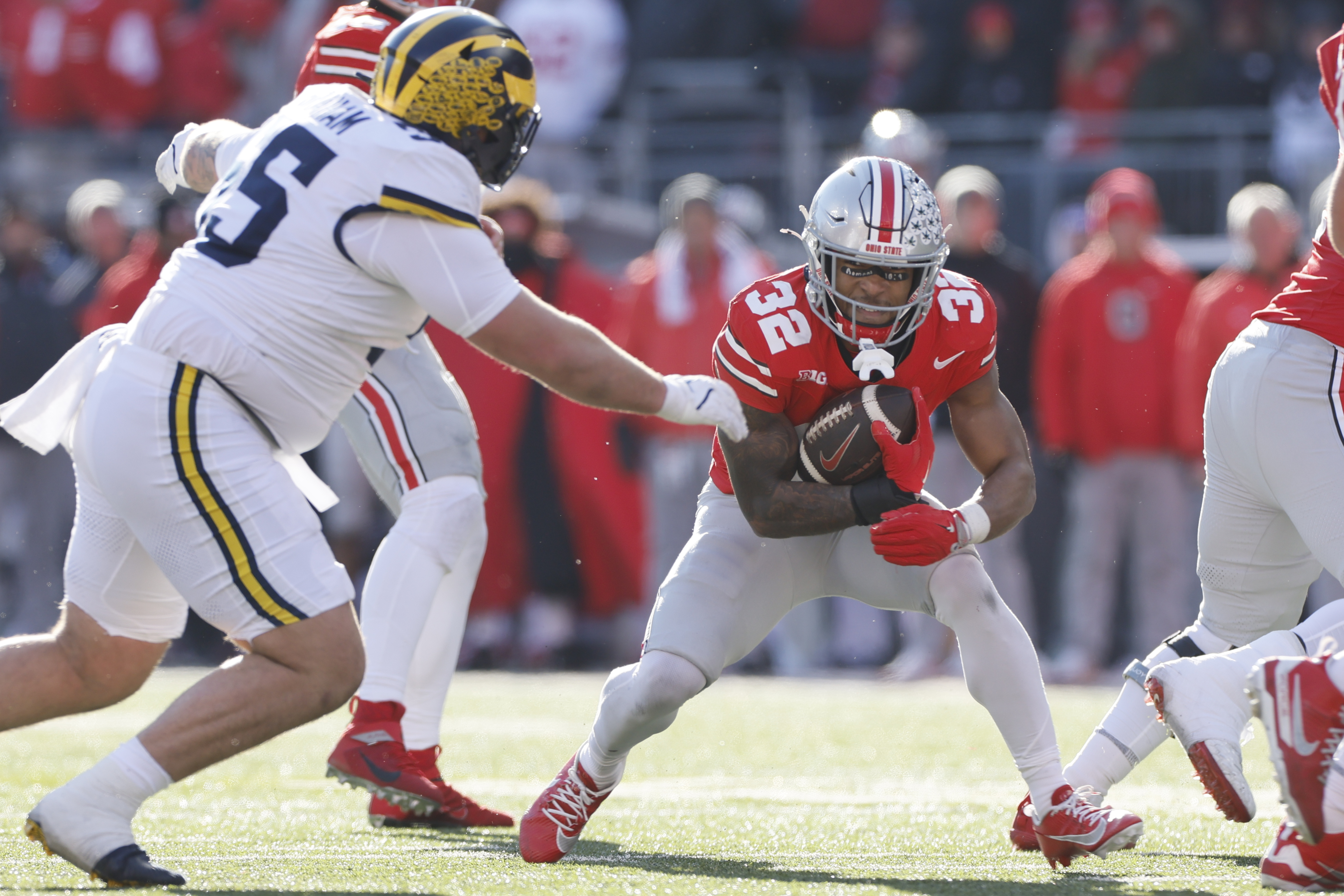 Ohio State running back TreVeyon Henderson, right, tries to run past Michigan defensive lineman Mason Graham during the second half of an NCAA college football game Saturday, Nov. 30, 2024, in Columbus, Ohio.