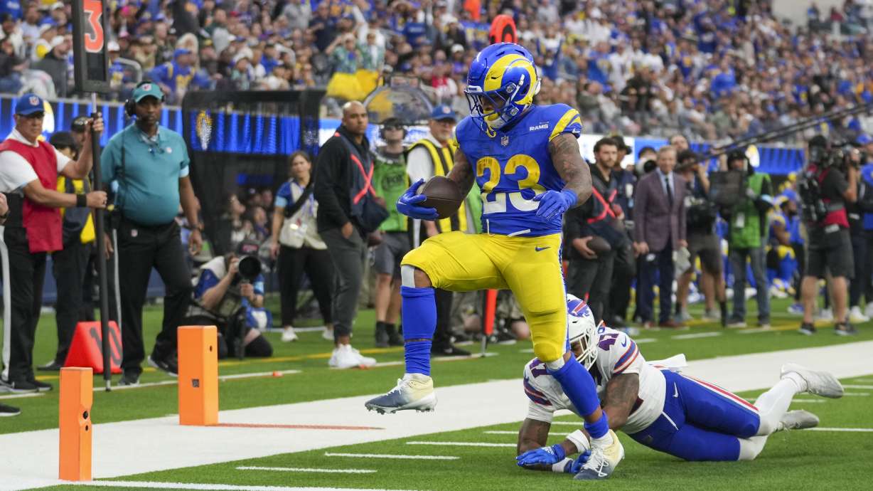 Los Angeles Rams running back Kyren Williams (23) avoids a tackle by Buffalo Bills cornerback Christian Benford (47) while scoring a touchdown during the second half of an NFL football game, Sunday, Dec. 8, 2024, in Inglewood, Calif.