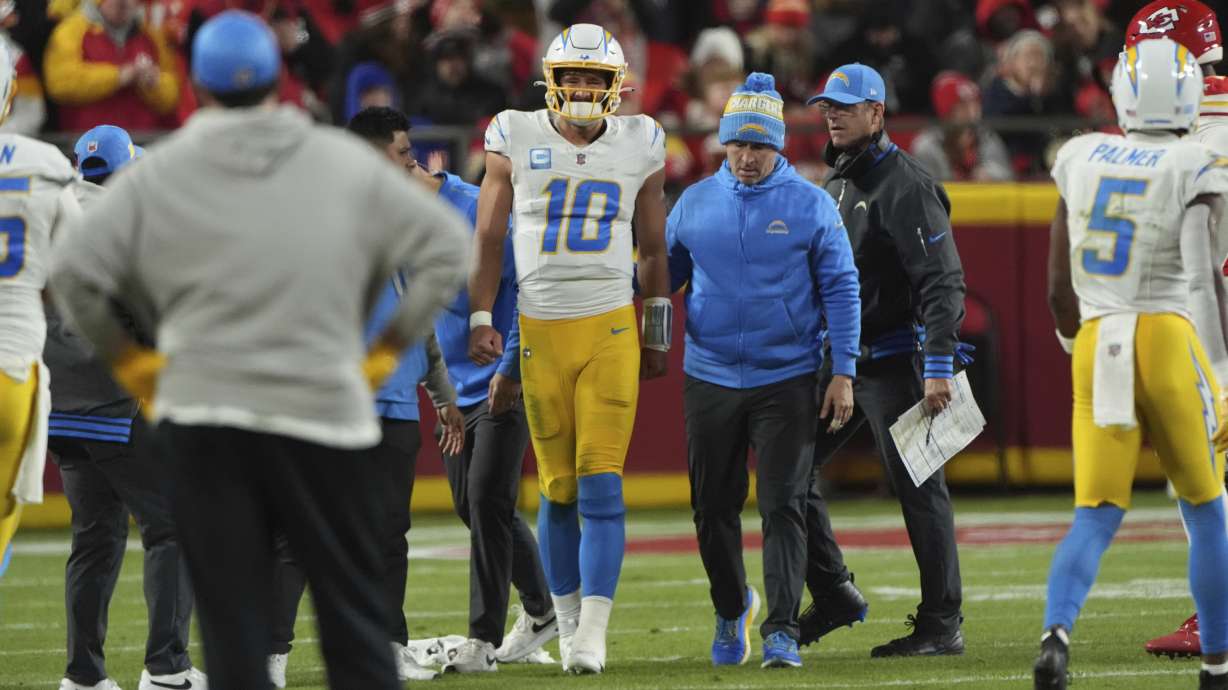 Los Angeles Chargers quarterback Justin Herbert (10) walks off the field after being injured during the first half of an NFL football game against the Kansas City Chiefs Sunday, Dec. 8, 2024, in Kansas City, Mo.
