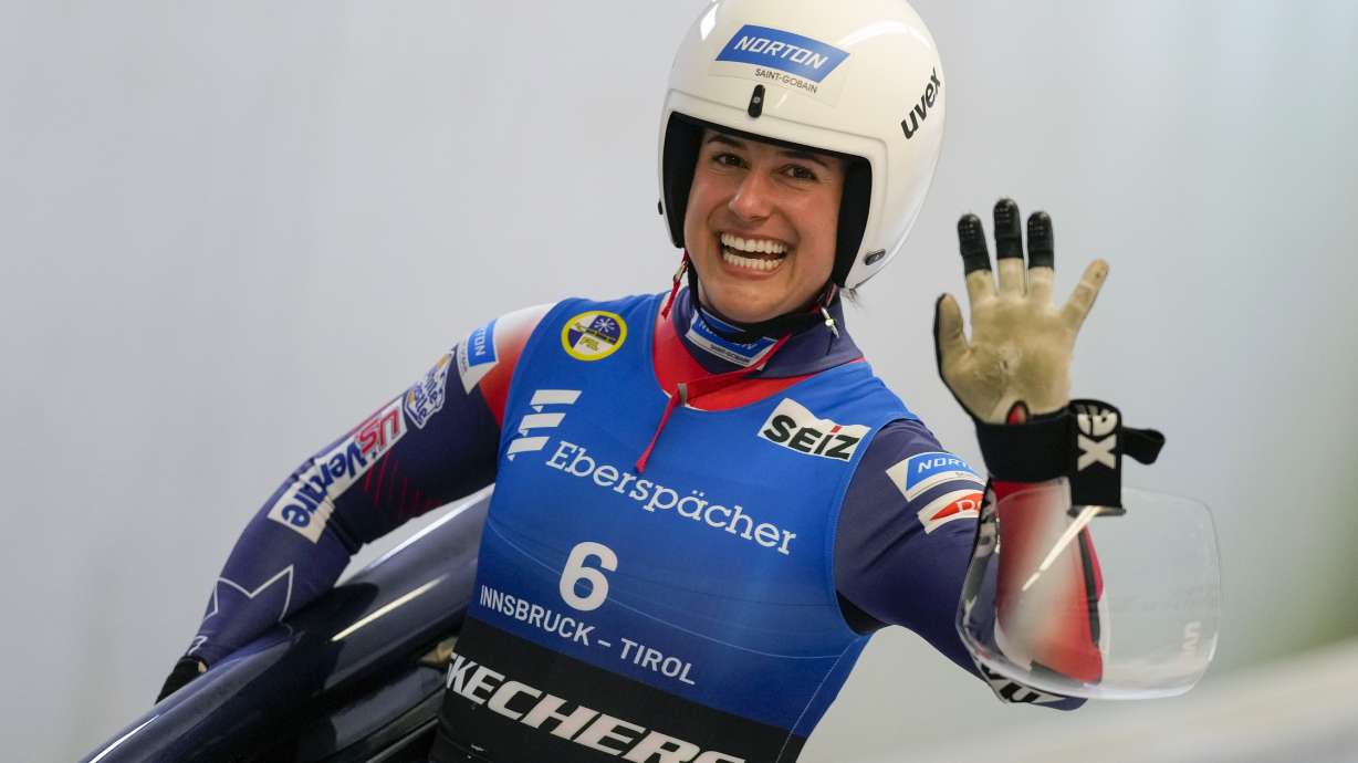 Emily Sweeney of the United States waves after the women's sprint race at the Luge World Cup in Igls near Innsbruck, Austria, Saturday, Dec. 7, 2024.