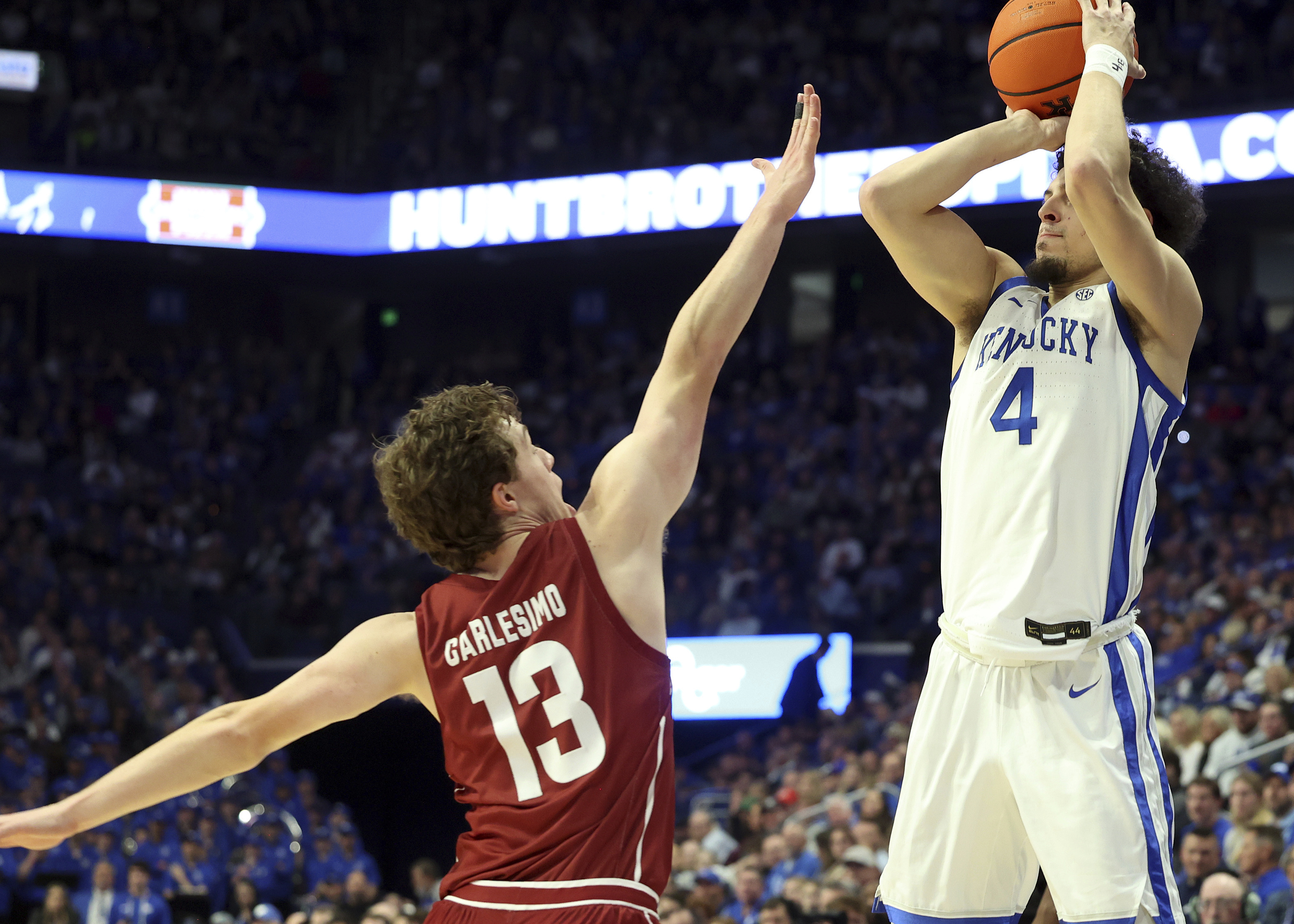 Kentucky's Koby Brea (4) shoots while pressured by Colgate's Kyle Carlesimo (13) during the first half of an NCAA college basketball game in Lexington, Ky., Wednesday, Dec. 11, 2024.