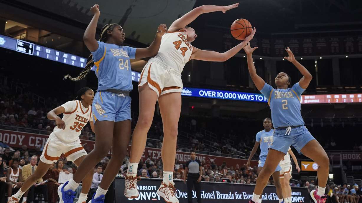 Texas forward Taylor Jones (44) grabs a rebound over Southern guard Aleighyah Fontenot (2) during the first half of an NCAA college basketball game in Austin, Texas, Wednesday, Dec. 11, 2024.
