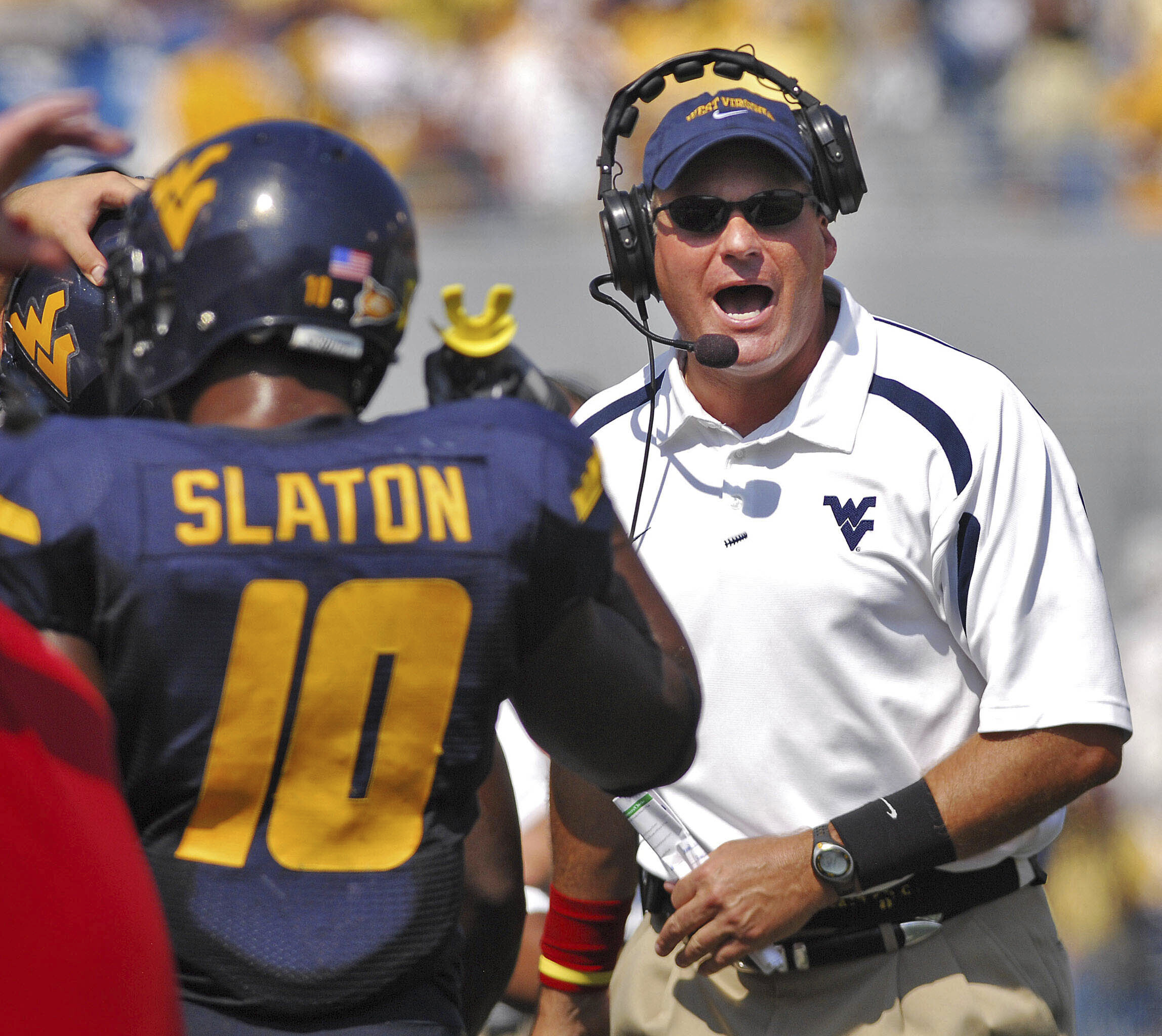 FILE - West Virginia coach Rich Rodriguez yells onto the field during the second half of a college football game against East Carolina in this Sept. 22, 2007 file photo, in Morgantown, W.Va.
