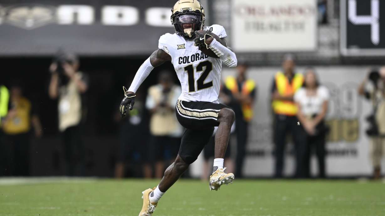 FILE - Colorado wide receiver Travis Hunter (12) runs after catching a pass during the first half of an NCAA college football game against Central Florida, Saturday, Sept. 28, 2024, in Orlando, Fla.