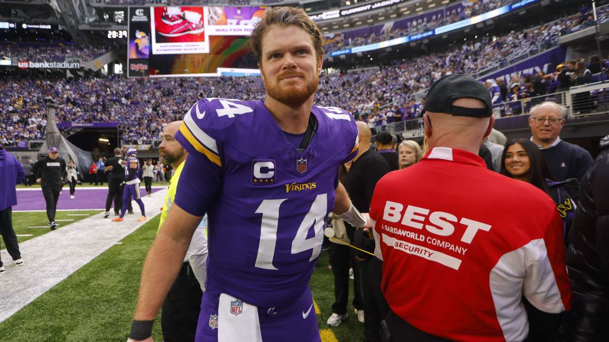 Minnesota Vikings quarterback Sam Darnold talks with fans before an NFL football game against the Atlanta Falcons, Sunday, Dec. 8, 2024, in Minneapolis.