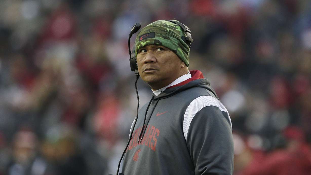 Washington State running backs coach Mark Atuaia stands on the field Mark Atuaia during a break in the game in the second half of an NCAA college football game against Arizona State, Saturday, Nov. 12, 2022, in Pullman, Wash.