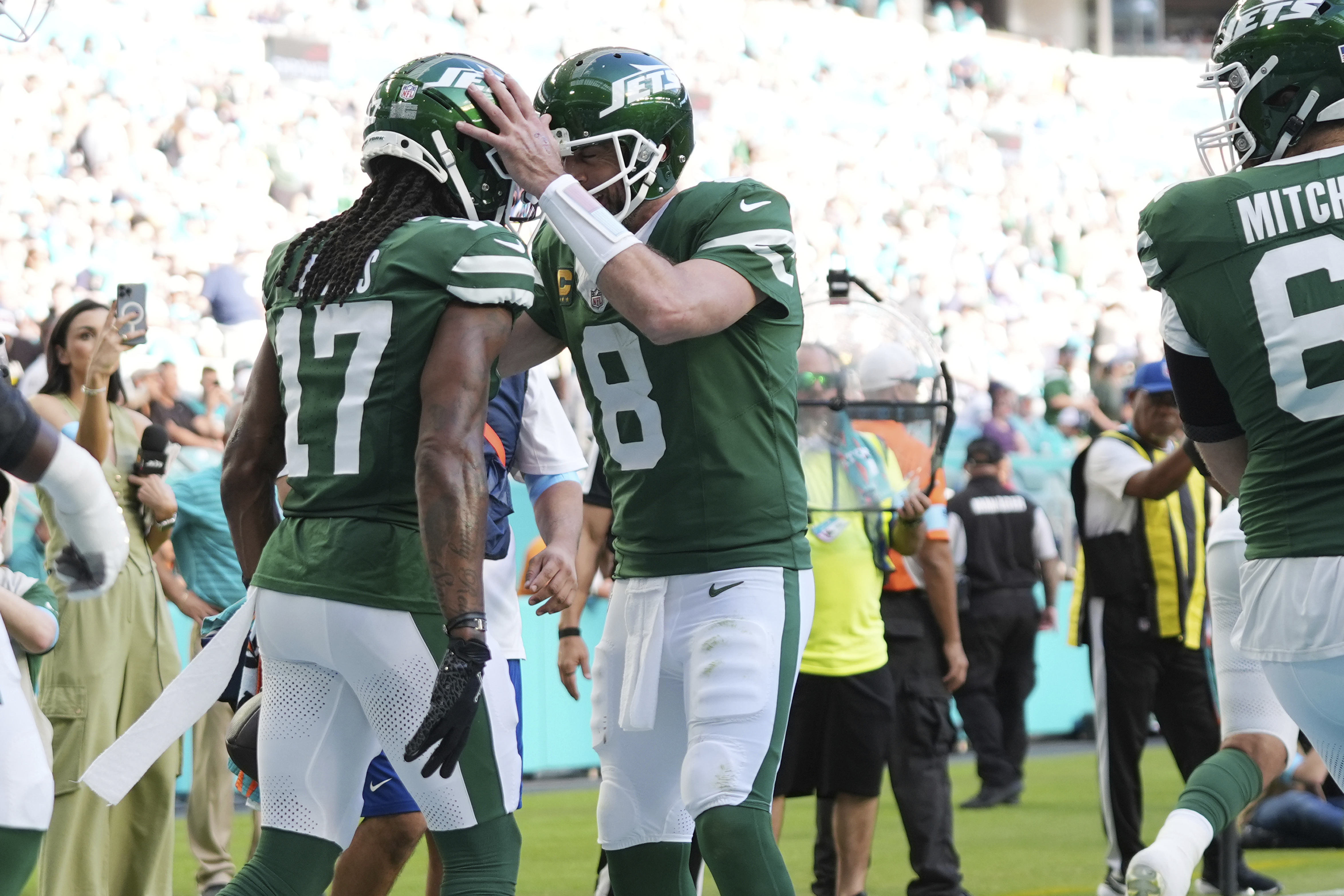 New York Jets quarterback Aaron Rodgers (8) and New York Jets wide receiver Davante Adams (17) celebrate a touchdown during the second half of an NFL football game against the Miami Dolphins, Sunday, Dec. 8, 2024, in Miami Gardens, Fla.