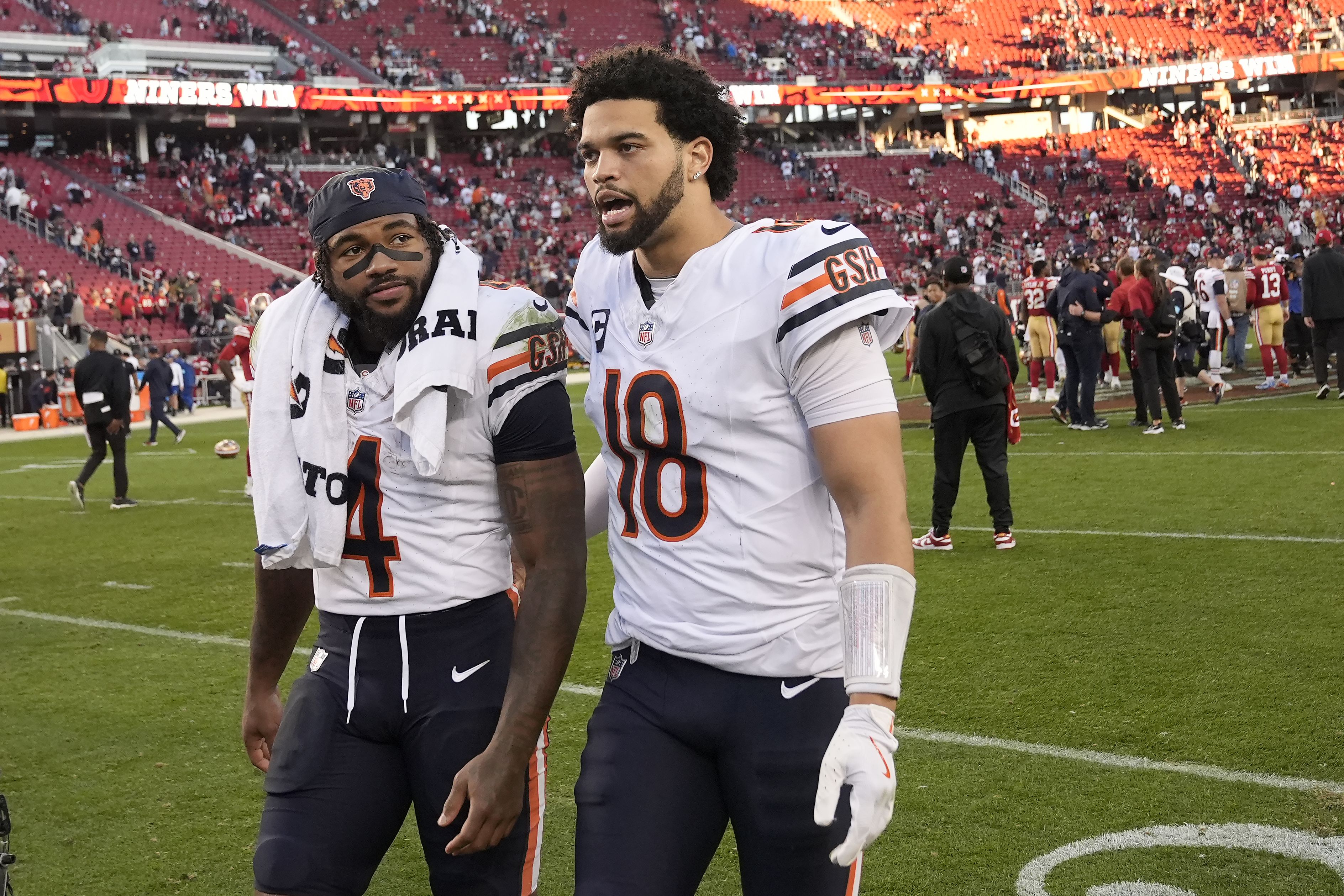 Chicago Bears running back D'Andre Swift (4) and quarterback Caleb Williams (18) walk off the field after an NFL football game against the San Francisco 49ers in Santa Clara, Calif., Sunday, Dec. 8, 2024.