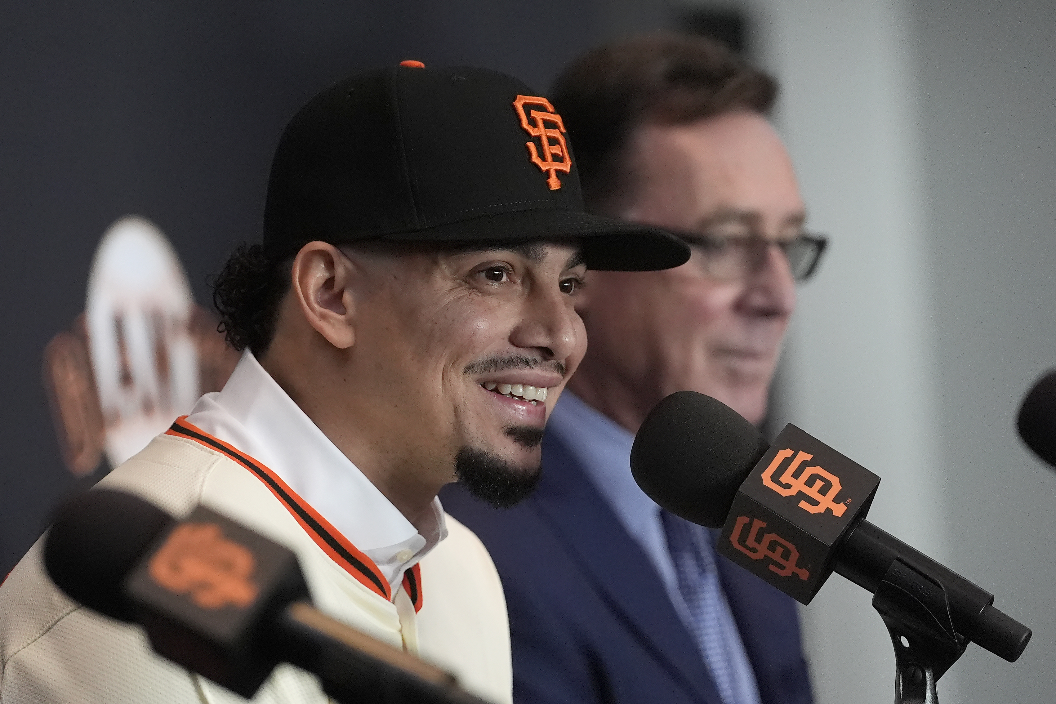 San Francisco Giants shortstop Willy Adames, left, speaks as Bob Melvin, right, listens during a baseball news conference in San Francisco, Thursday, Dec. 12, 2024.