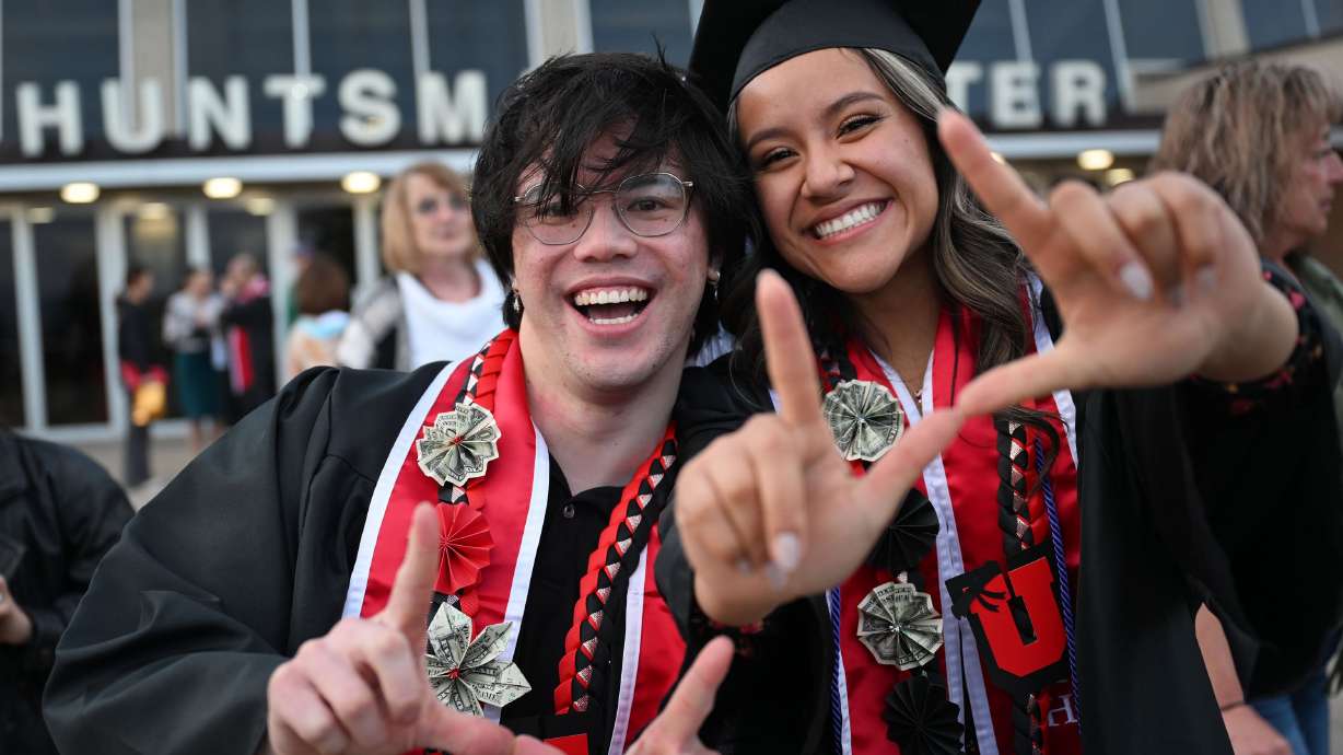 Jack Rogers and Emily Meza hold up their U’s after commencement ceremonies at the University of Utah in Salt Lake City on May 2. Once again this year, the Utah System of Higher Education says women are attending Utah's public colleges and universities in greater numbers than men.