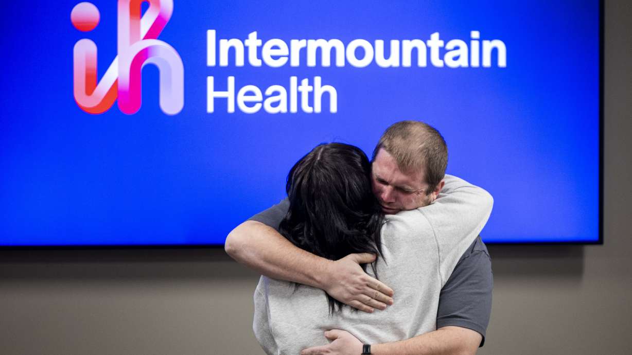 Kevan Elkins hugs Cameron Connelly during a ceremony to honor her, a Pleasant Grove Fire Department paramedic, and first responders on Thursday. Elkins was saved by the off-duty nurse and paramedic when he went into cardiac arrest at a gym.