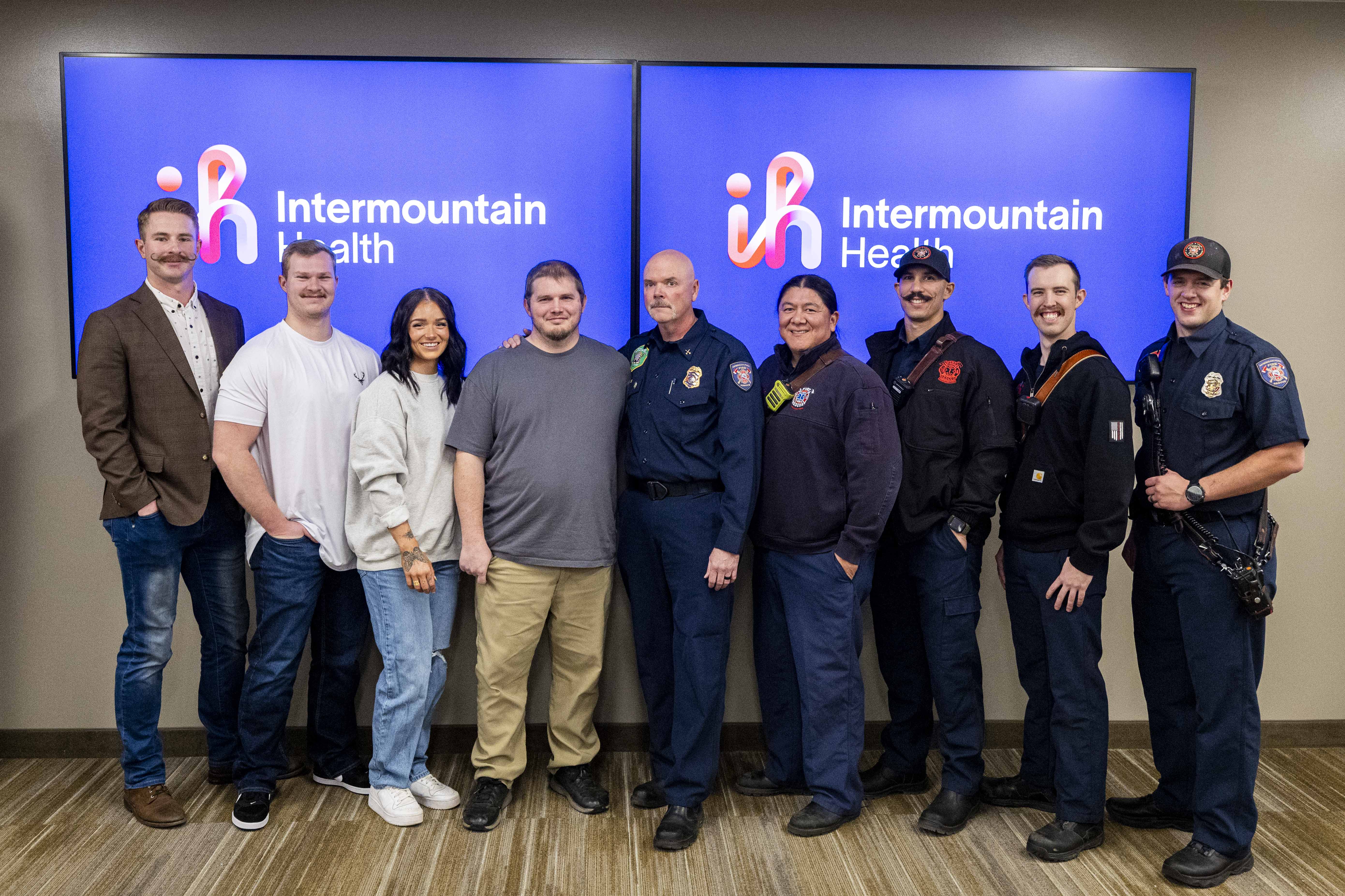 Pleasant Grove resident Kevan Elkins, fourth from left, poses for a photo with Cameron Connelly, an emergency room nurse from Intermountain American Fork Hospital, third from left, and her husband, Colten Connelly, second from left, Curtis Hutchinson, a Pleasant Grove Fire Department paramedic, left, and first responders from American Fork Fire Station No. 51, all of whom helped save Elkins’ life after they were recognized in a ceremony held at American Fork Hospital in American Fork on Thursday.