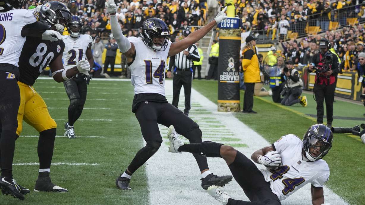 Baltimore Ravens safety Kyle Hamilton (14) reacts after teammate cornerback Marlon Humphrey (44) intercepted a pass in the end zone by the Pittsburgh Steelers during the second half of an NFL football game, Sunday, Nov. 17, 2024, in Pittsburgh.
