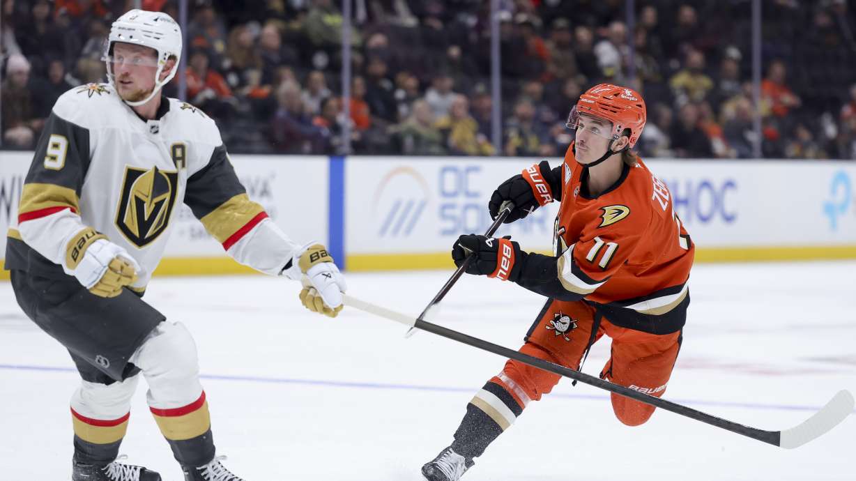 Anaheim Ducks center Trevor Zegras, right, watches his shot next to Vegas Golden Knights center Jack Eichel during the third period of an NHL hockey game Wednesday, Nov. 13, 2024, in Anaheim, Calif.