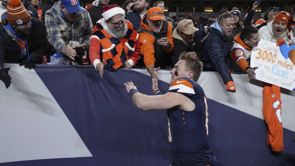 Denver Broncos quarterback Bo Nix celebrates with fans following an NFL football game against the Cleveland Browns, Monday, Dec. 2, 2024, in Denver.