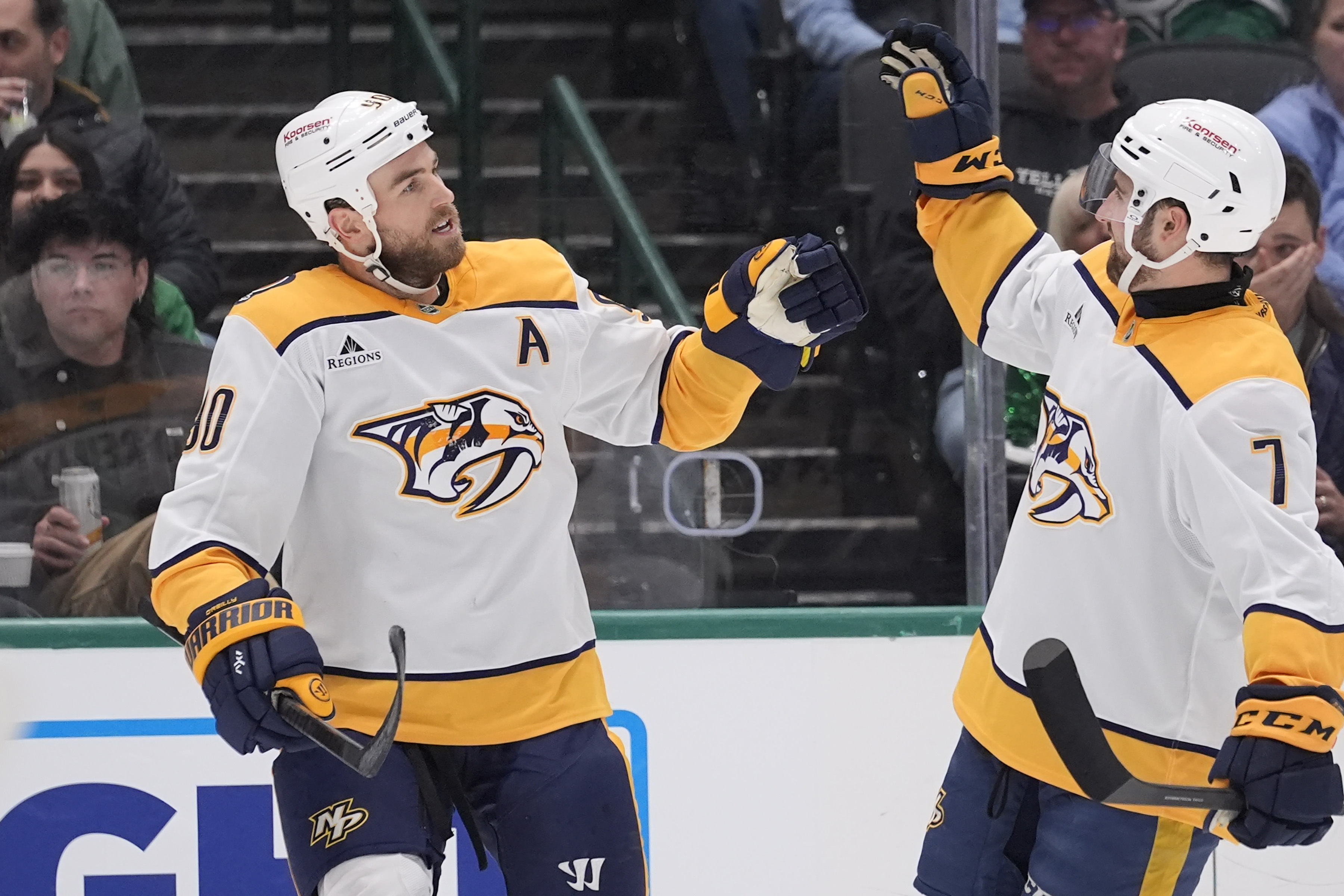 Nashville Predators center Ryan O'Reilly (90) celebrates his goal with teammate Marc Del Gaizo (7) in the second period of an NHL hockey game against the Dallas Stars Thursday, Dec. 12, 2024, in Dallas.
