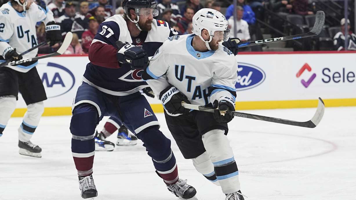 Utah Hockey Club center Alexander Kerfoot, right, looks for a pass as Colorado Avalanche defenseman Keaton Middleton covers in the second period of an NHL hockey game Thursday, Dec. 12, 2024, in Denver.