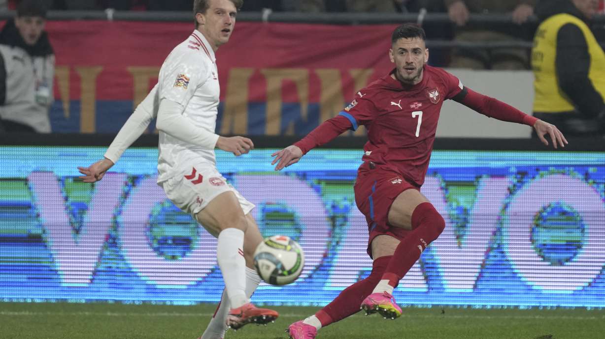 Serbia's Aleksa Terzic passes the ball by Denmark's Mads Roerslev during the UEFA Nations League soccer match between Serbia and Denmark at the Dubocica Stadium in Leskovac, Serbia, Monday, Nov. 18, 2024.