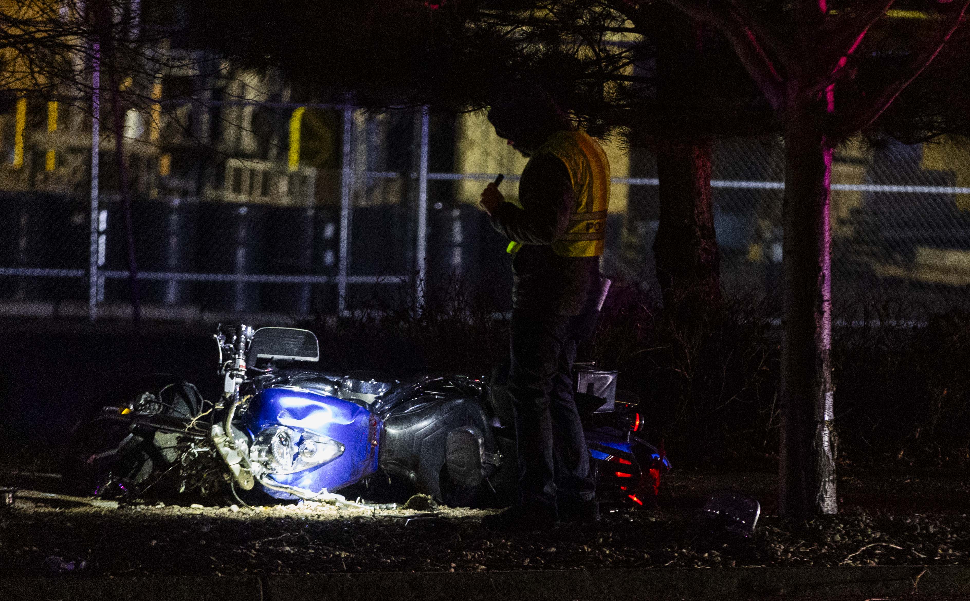 Police investigate the scene of a accident where a motorcycle left the roadway and struck a tree, and one male patient in his 40s was transported to the hospital in critical condition, in Midvale on Thursday.