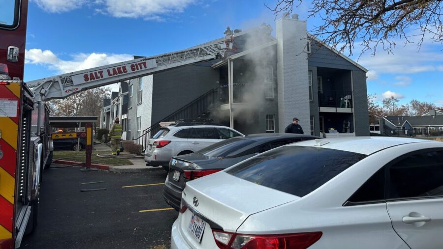 Crews work to extinguish a fire at an apartment complex in Rose Park on Monday. About 12 people were displaced.