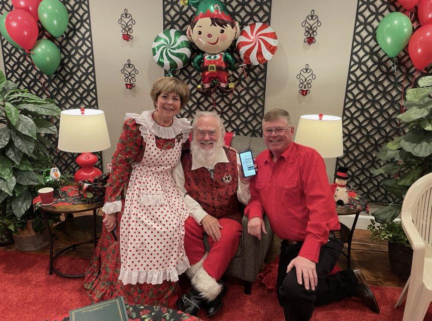 Kerri and Ron Robbins in their home with Santa Claus last December.