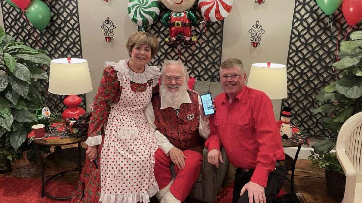 Kerri and Ron Robbins in their home with Santa Claus last December.