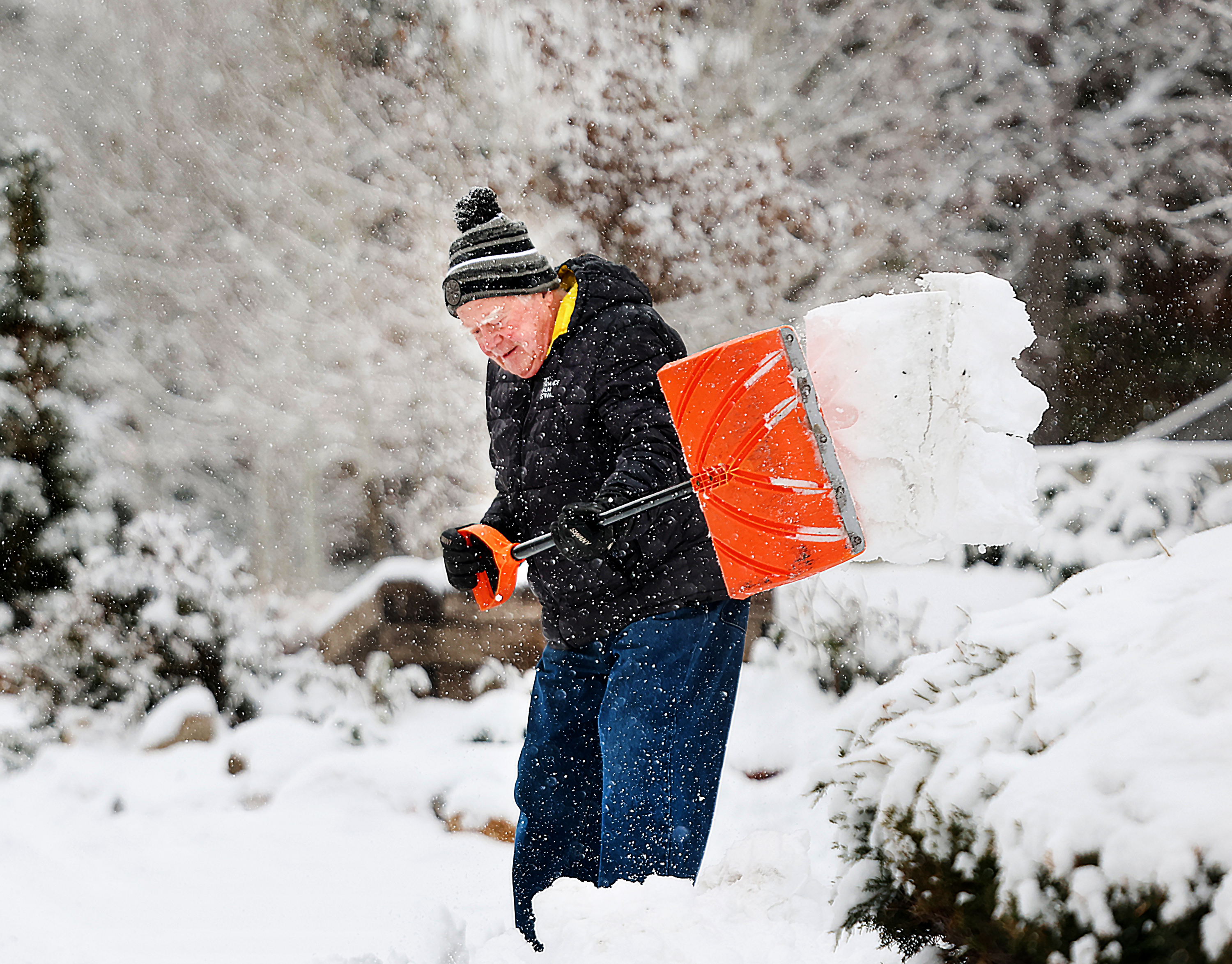 Jack Hamilton shovels his driveway in Salt Lake City on Friday. A storm that passed through Utah's northern half on Friday performed better than expected, and a winter weather advisory is in place for another storm on the way.