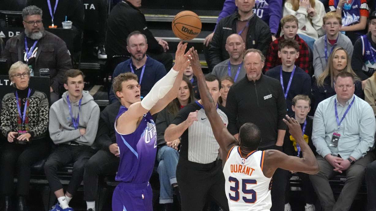 Utah Jazz forward Lauri Markkanen, left, shoots as Phoenix Suns forward Kevin Durant (35) defends during the first half of an NBA basketball game Friday, Dec. 13, 2024, in Salt Lake City.