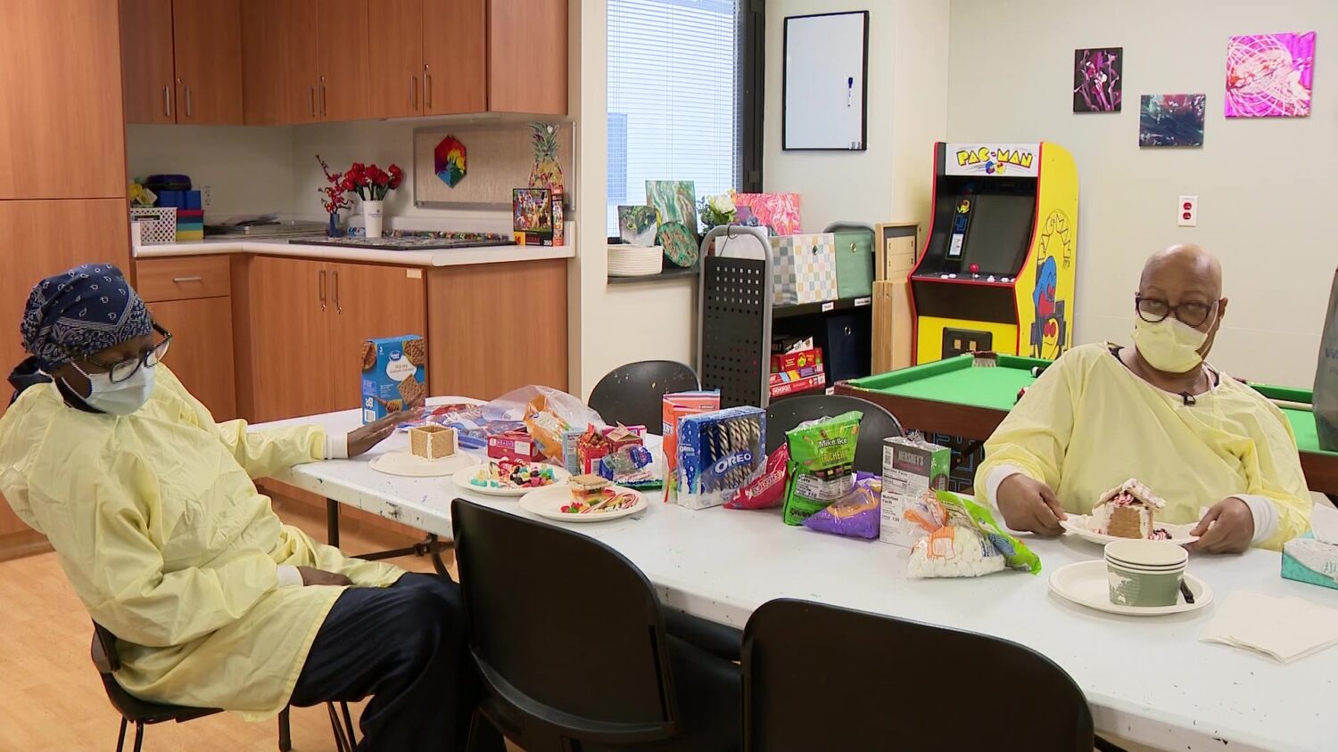 Irma McCoy, left, and Evelyn Ealy make gingerbread houses in the hospital’s recreation room in this undated photo.