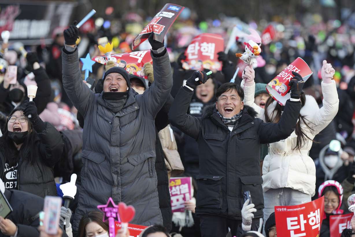 Participants celebrate after hearing the news that South Korea's parliament voted to impeach President Yoon Suk Yeol outside the National Assembly in Seoul, South Korea, on Saturday.