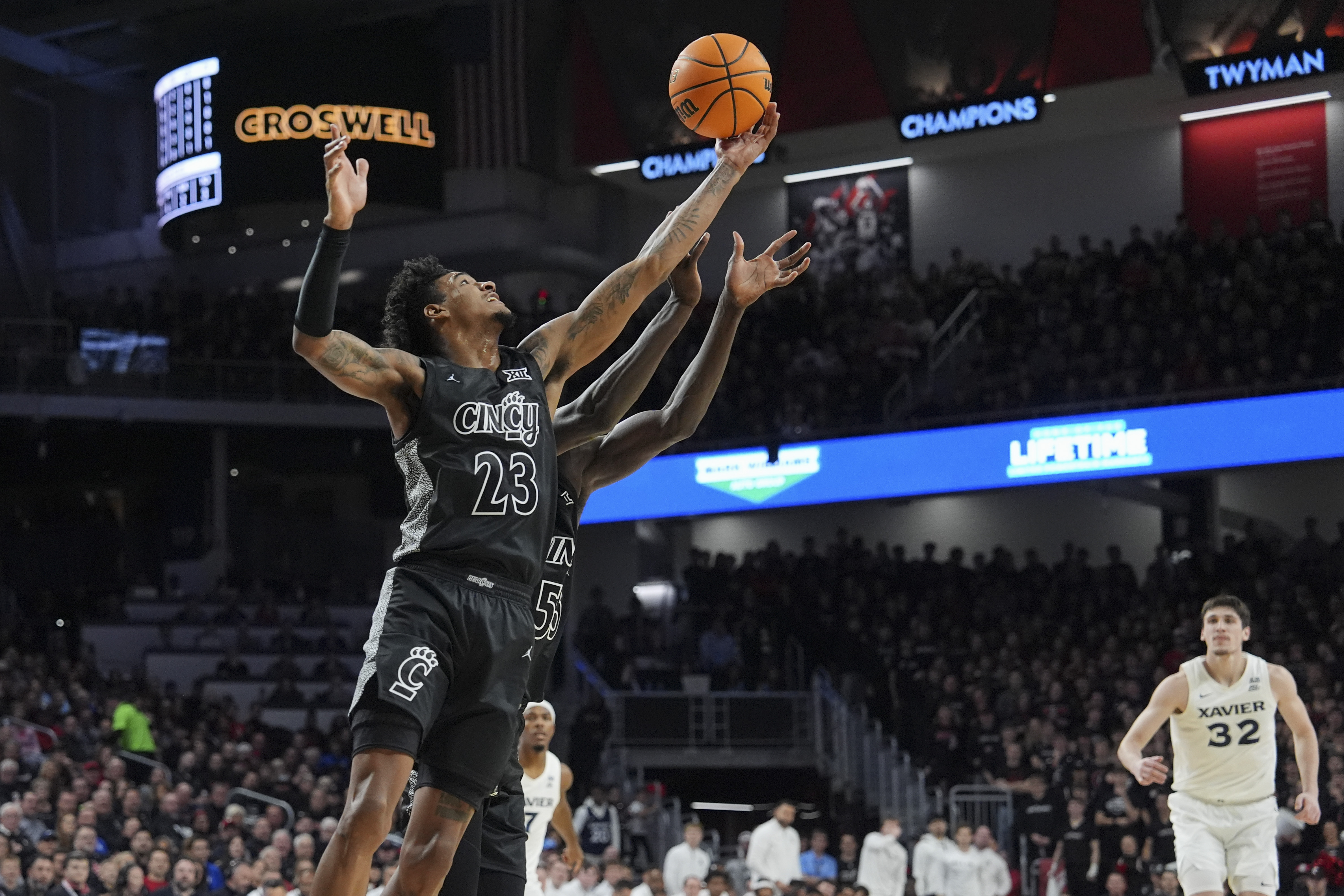 Cincinnati forward Dillon Mitchell rebounds the ball during the first half of an NCAA basketball game against Xavier, Saturday, Dec. 14, 2024, in Cincinnati.