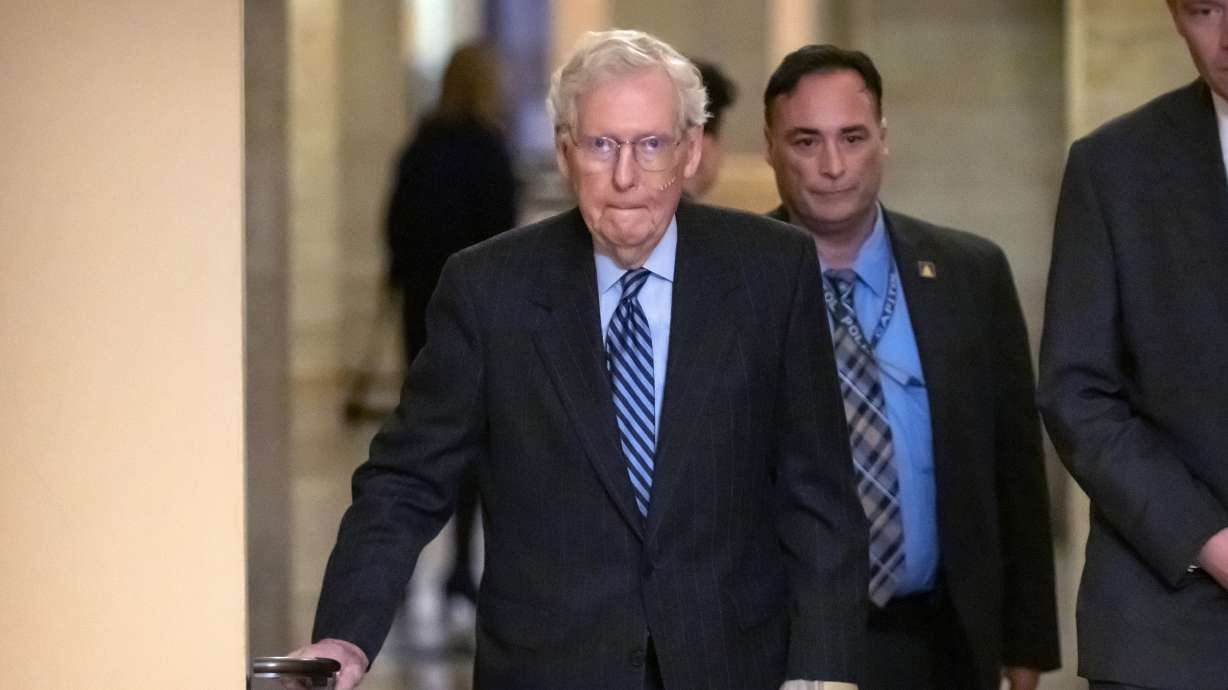 Senate Minority Leader Mitch McConnell of Ky., left, walks to the Senate floor on Capitol Hill, Dec. 10 in Washington. McConnell said any of President-elect Donald Trump's picks requiring Senate confirmation should "steer clear" of efforts to discredit the polio vaccine.