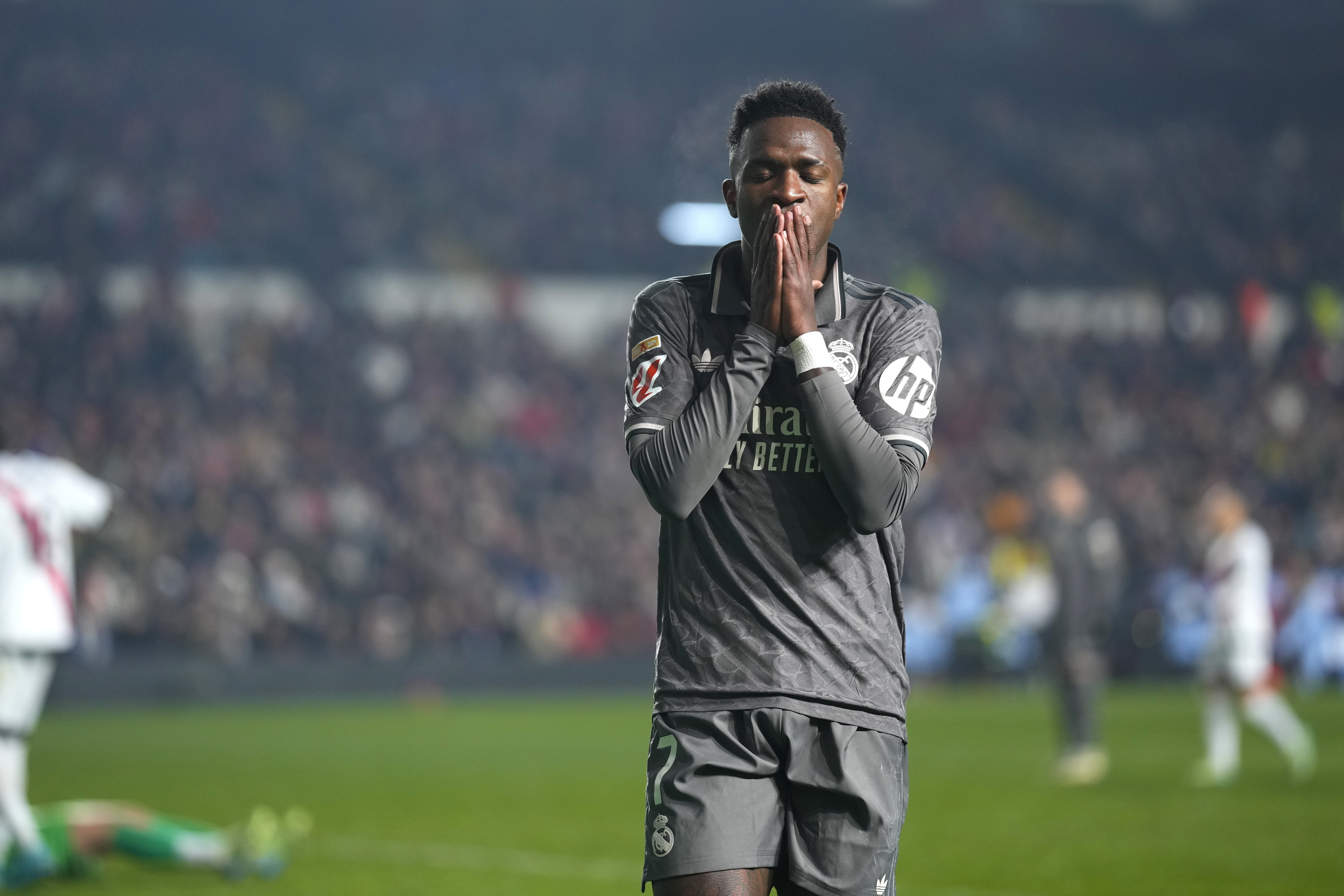 Real Madrid's Vinicius Junior reacts during the Spanish La Liga soccer match between Rayo Vallecano and Real Madrid at the Vallecas stadium in Madrid, Spain, Saturday, Dec. 14, 2024.