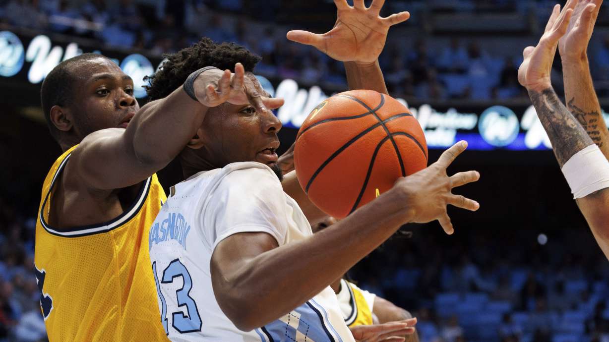 North Carolina's Jalen Washington (13) loses the ball as La Salle's Demetrius Lilley, left, defends during the first half of an NCAA college basketball game in Chapel Hill, N.C., Saturday, Dec. 14, 2024.