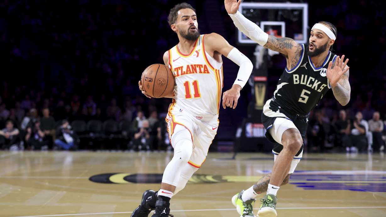 Atlanta Hawks guard Trae Young (11) drives past Milwaukee Bucks guard Gary Trent Jr. (5) during the first half of a semifinal game in the NBA Cup basketball tournament Saturday, Dec. 14, 2024, in Las Vegas.