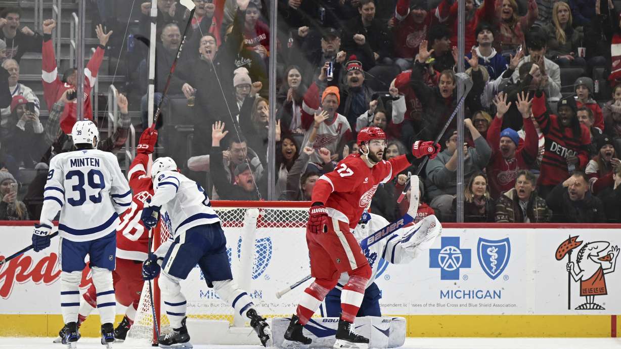 Detroit Red Wings center Michael Rasmussen (27) reacts with the fans after Detroit Red Wings defenseman Jeff Petry (46) scored a goal against the Toronto Maple Leafs during the first period of an NHL hockey game, Saturday, Dec. 14, 2024 in Detroit.