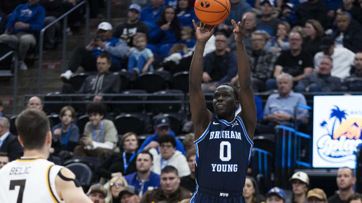 Brigham Young forward Mawot Mag (0) puts up a three during a game between the Brigham Young Cougars and the Wyoming Cowboys at the Delta Center in Salt Lake City on Saturday, Dec. 14, 2024.