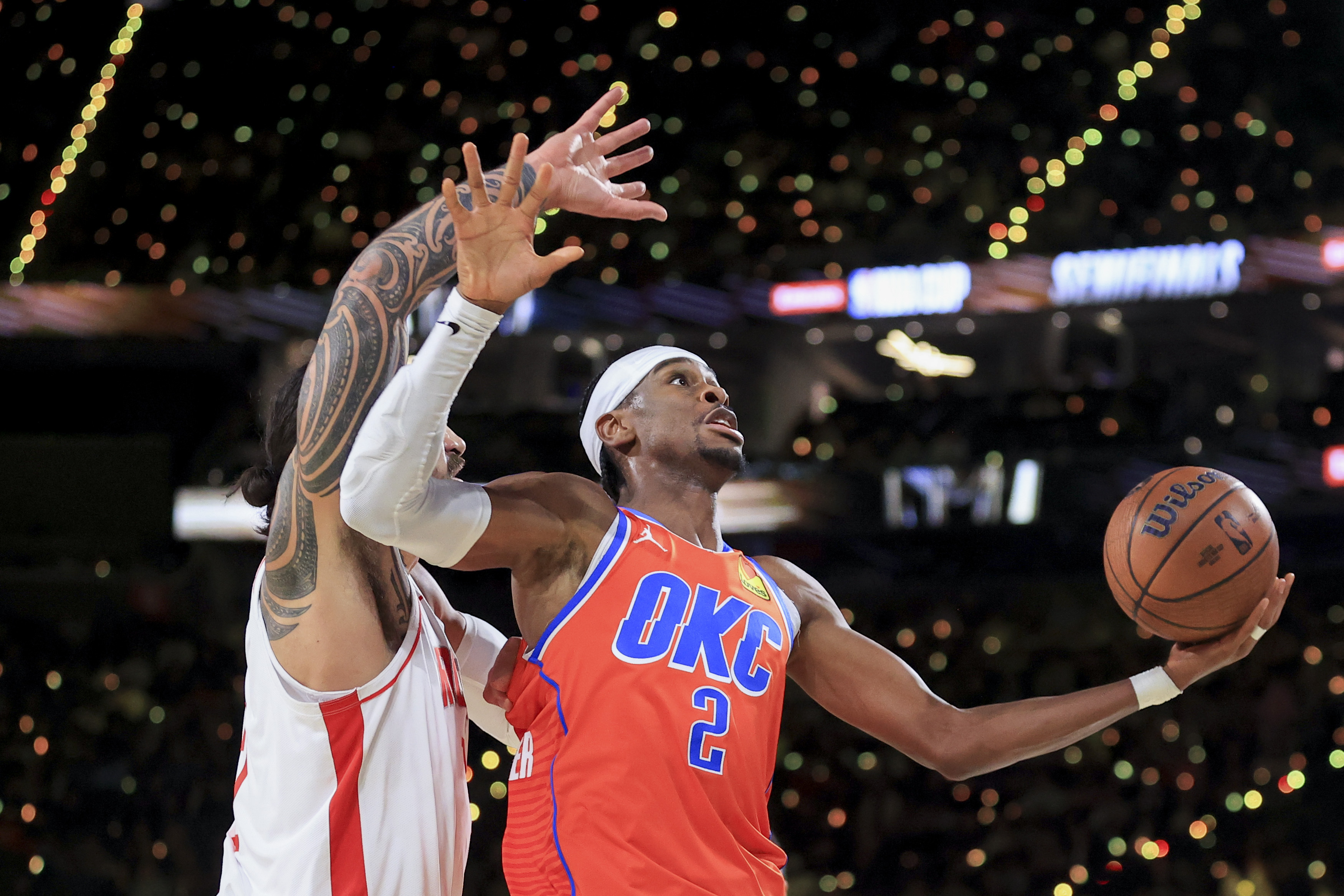 Oklahoma City Thunder guard Shai Gilgeous-Alexander (2) looks to shoot against Houston Rockets center Steven Adams, left, during the first half of a semifinal game in the NBA Cup basketball tournament Saturday, Dec. 14, 2024, in Las Vegas.