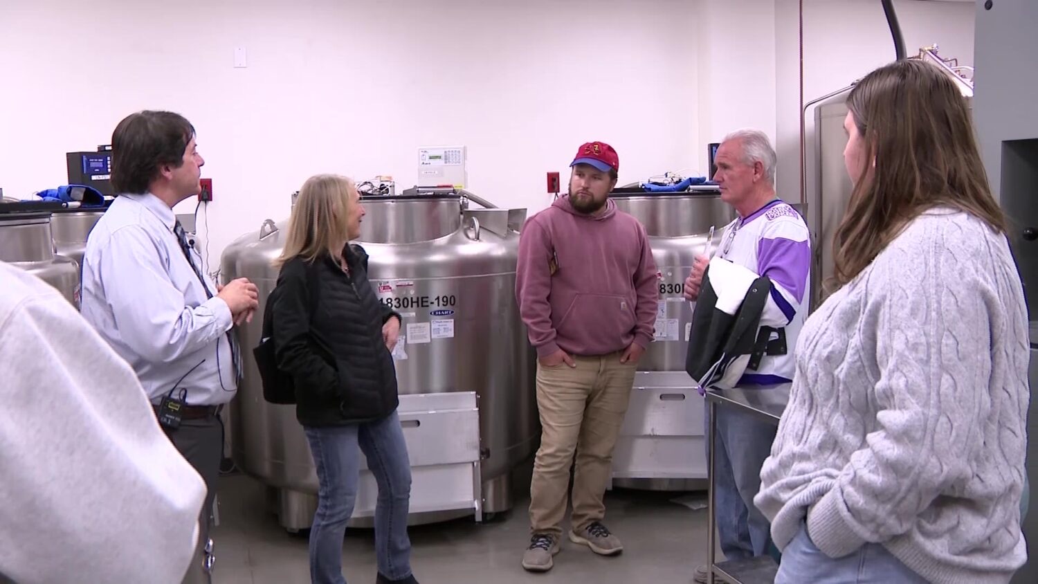 Gina Poirier, center left, and Doug Wood, center right, were part of a group meeting inside the University of Utah Cell Therapy a Regenerative Medicine lab on Thursday. Wood donated stem cells that were used to help Poirer in 2019.